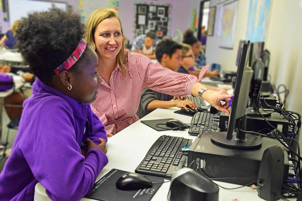 Teacher and student at computer